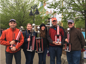 Music teachers holding trophies 